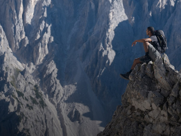 A hiker sitting on top of a mountain