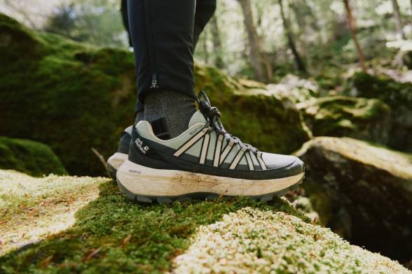 Photo of three hiking packs on rocky ground